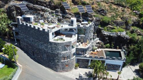 an aerial view of a house with solar panels at Castelo do Mar, Madeira in Tábua