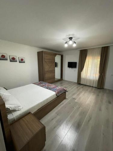 a bedroom with a bed and a television in it at Villa in Old Tbilisi in Tbilisi City