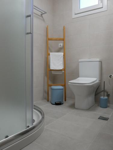 a bathroom with a white toilet and a shower at TH Studio in Myrina