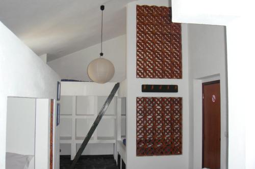 a hallway with white walls and a door with a pendant at Casa da Malta do Monte dos Arneiros in Lavre