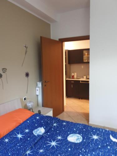 a bedroom with a bed with a blue blanket with stars on it at Romeo1 in Gallarate