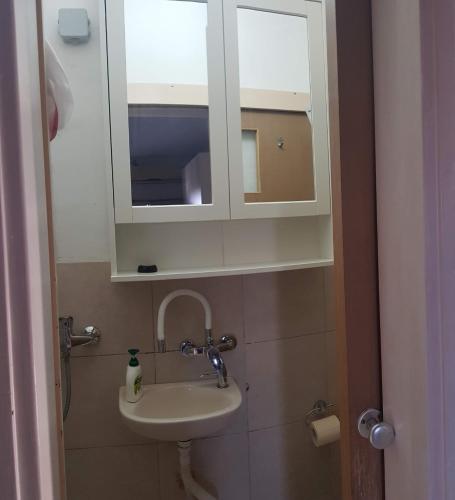 a bathroom with a sink and a medicine cabinet at Cozy Flat with Parking well-placed near TLV Airport in Lod