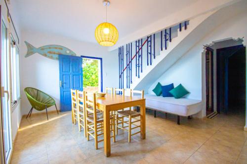 a dining room with a table and a couch at Alfacs Village in Les Cases d'Alcanar