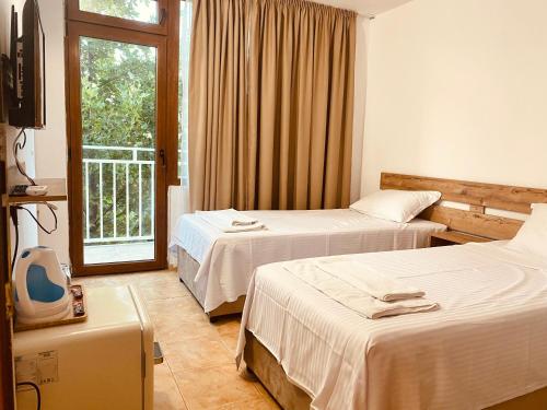 a hotel room with two beds and a window at Casa Beach in Ravda