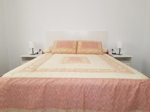 a bedroom with a large bed with two night stands at Vv CASA JULIA in Valverde