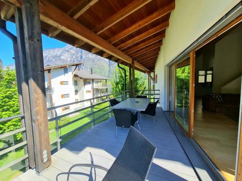a patio with chairs and a table on a balcony at Walensee House & Apartments in Unterterzen