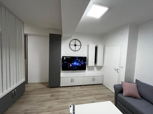 a living room with a tv on a white wall at Stefanoski Apartments in Skopje
