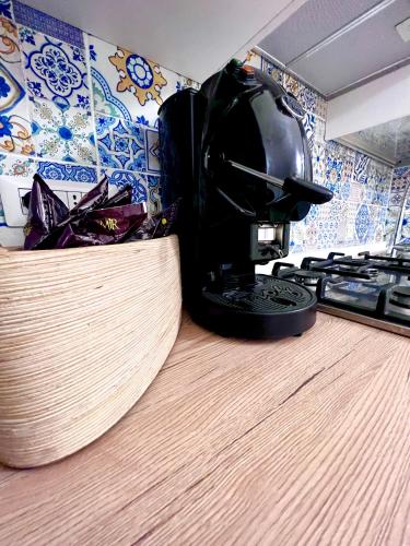 a coffee maker sitting on top of a kitchen counter at DOMUS HENRICUS -THREEROOM APARTMENT IN PORTO POLLO 400 Meters from the sea in Porto Pollo