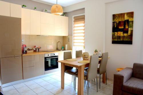 a kitchen and dining room with a wooden table and chairs at M home place in Palio Limani