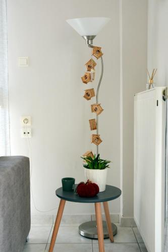 a table with a lamp and a plant on it at M home place in Palio Limani