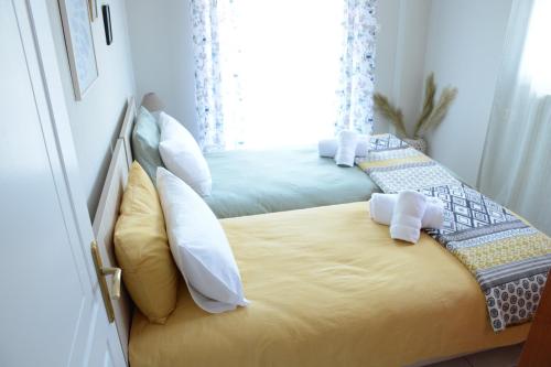 a bedroom with two beds with pillows at M home place in Palio Limani