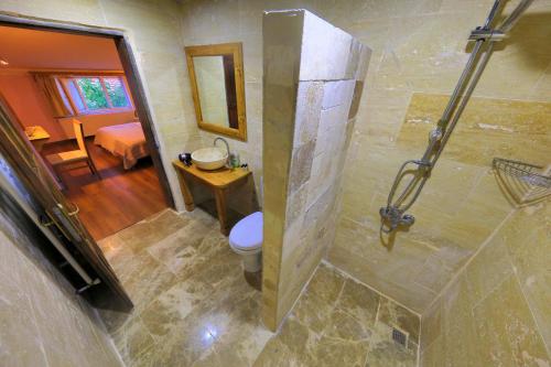 a bathroom with a shower with a toilet in it at Alphan Cappadocia in Uchisar