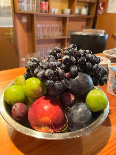 a bowl of fruit sitting on a table at Penzion Siesta Grand in Hrabušice