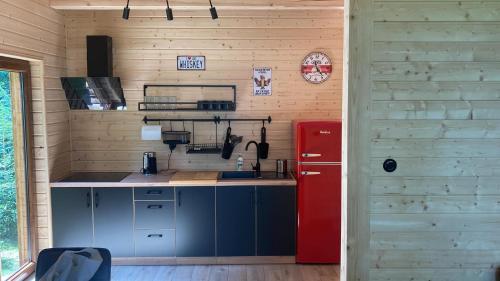a kitchen with a red refrigerator in a room at Ostoja Leśniewo in Srokowo