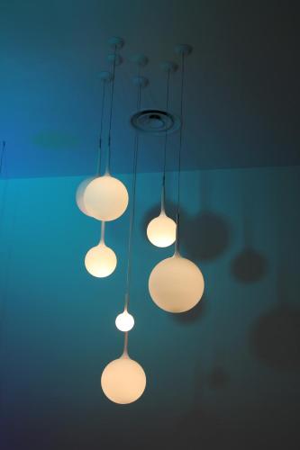 a group of lights hanging from a ceiling at JC Hotel in Rome