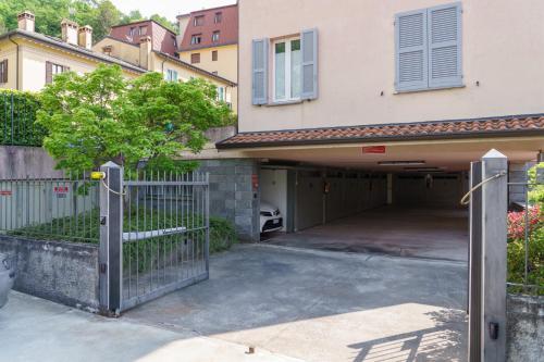 a garage with a gate in front of a house at Casa Aidee in Varenna