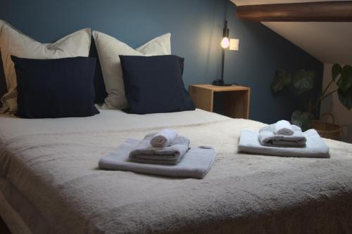 a bed with towels and pillows on it at Maison 1862 - Hébergements d'hôte in Orsan