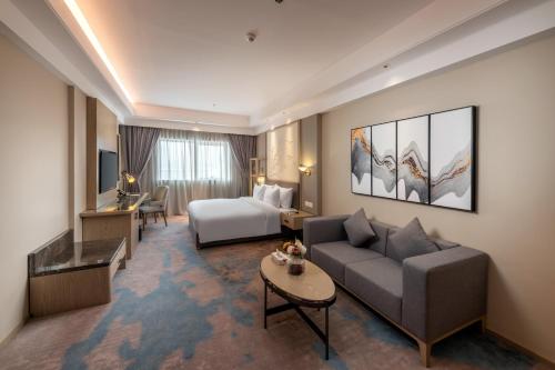 um quarto de hotel com uma cama e um sofá em Aber Bani Amr em Al Namas