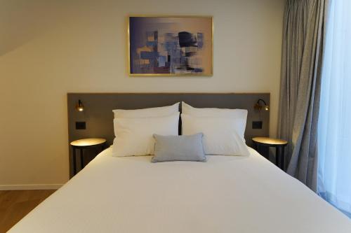 Postel nebo postele na pokoji v ubytování Urbanic Hotel