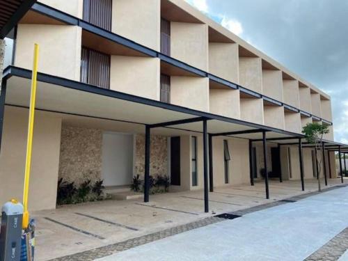 a large building with an empty parking lot at New & beautiful apartment GF with private pool in Mérida