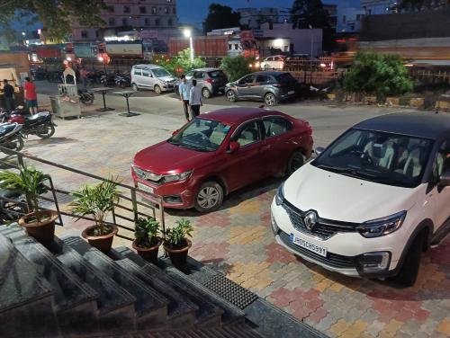 two cars parked in a parking lot at night at The Jamun Tree in Muzaffarpur