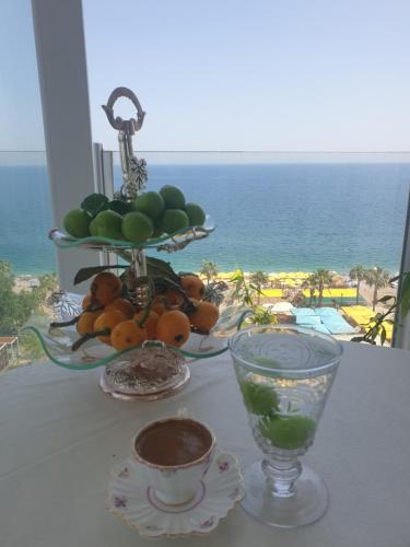 a table with a bowl of fruit and a plate of fruit at Antalya Konyaaltında muhteşem GEMİ EV in Antalya