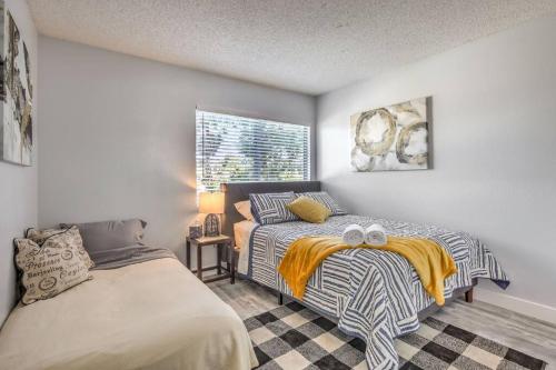 a bedroom with two beds and a window at Hidden Gem in the Desert -Gym/Pool/Spa/Games-4BR in Spring Valley