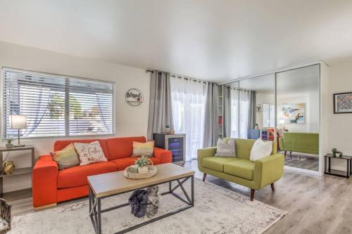 a living room with a red couch and two chairs at Hidden Gem in the Desert -Gym/Pool/Spa/Games-4BR in Spring Valley