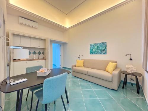 a living room with a table and a couch at Casa Adelaide in Capri