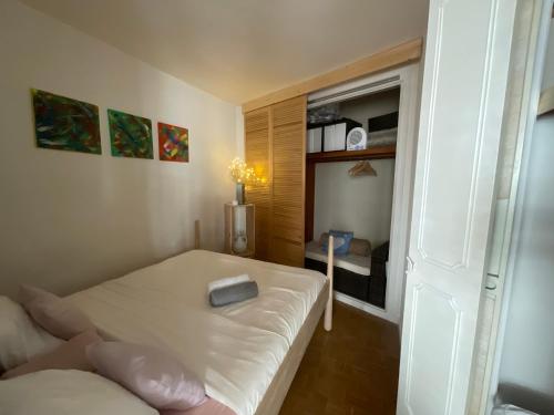 a bedroom with a bed with a book on it at St Catherine - Sweet home - Bxl - Studio Apartment with city view in Brussels