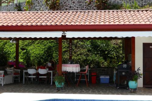 a patio with a table and chairs under awning at Bungalows Sanlaz in Barrio Jesús