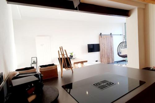 a living room with a table and a dining room at Mya Lenas Suite in Irrel