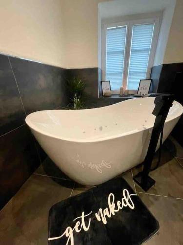 a white bath tub sitting in a bathroom at Mya Lenas Suite in Irrel
