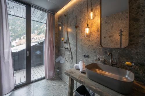 a bathroom with a sink and a shower at Paznauner Villen - Villa I in Kappl