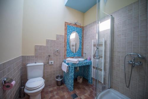a bathroom with a toilet and a sink and a mirror at Guesthouse Trajbar Team in Zaprešić