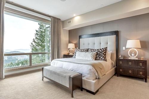 a bedroom with a large bed and a large window at Platinum Room Hotel Room in Park City