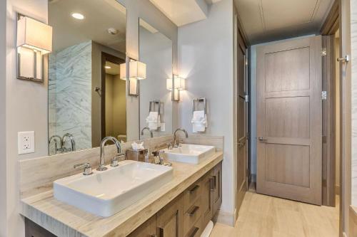 a bathroom with two sinks and a large mirror at Premium Room Hotel Room in Park City