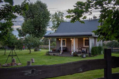 a small house with a fence in front of it at Lipowy Zakątek to miejsce bez gospodarzy i na wyłączność in Siemianówka
