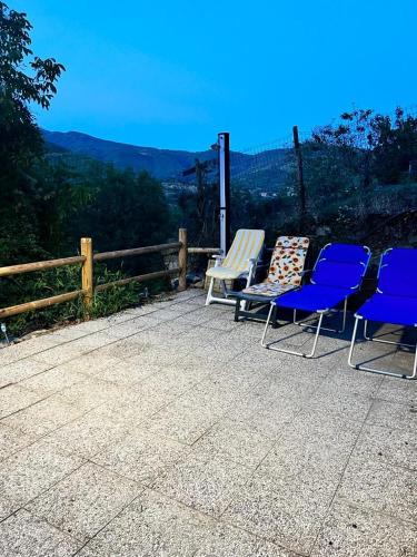 a group of chairs sitting on a patio with a view at THE DORMOUSE - Il Ghiro in Reusa