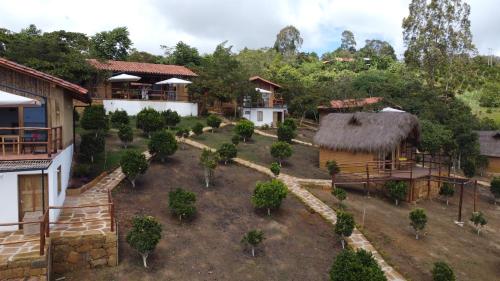 an aerial view of a village with houses and trees at Hotel Cariguá in Barichara