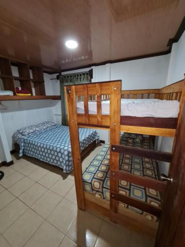 two bunk beds in a room with a bed at Casa Samia in Cahuita
