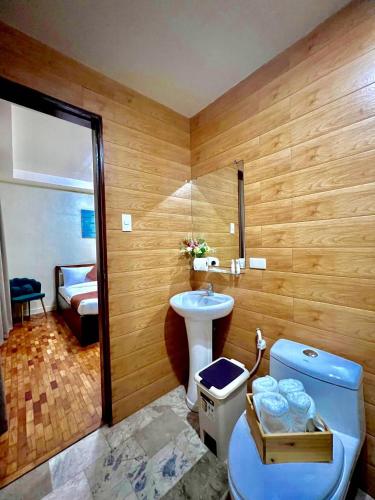 a bathroom with a toilet and a sink at Elliannah Pines Hotel in Baguio