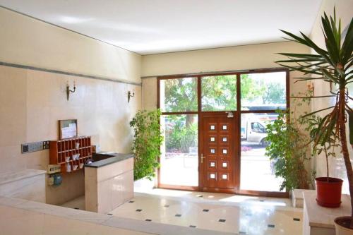 a large room with a door and a plant at Luxury at its best beach condo in Palaio Faliro in Athens