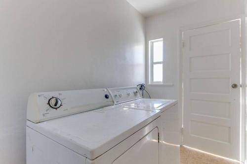 a white kitchen with a sink and a white door at 2 Bedroom Mid-Wilshire Charmer close to Downtown in Los Angeles