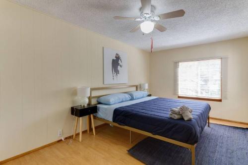 3 bedroom Mid-Wilshire Charmer near Downtown في لوس أنجلوس: غرفة نوم بسرير ومروحة سقف