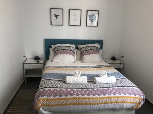 a bedroom with a bed with two towels on it at Apartment At The Beach -La Malagueta-Free Parking- in Málaga