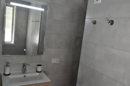 a bathroom with a sink and a mirror at Apartment At The Beach -La Malagueta-Free Parking- in Málaga