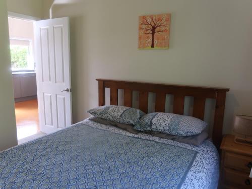 a bedroom with a bed with two pillows on it at Cosy Nights - modern, self-contained with parking in Kerikeri