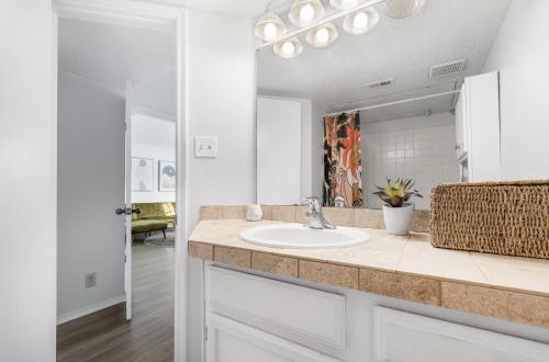 a bathroom with a sink and a mirror at Oceanside Retreat in Corpus Christi