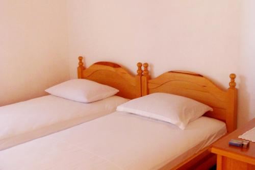 two beds sitting next to each other in a room at Secluded fisherman's cottage Cove Vela Proversa, Kornati - 9471 in Vala